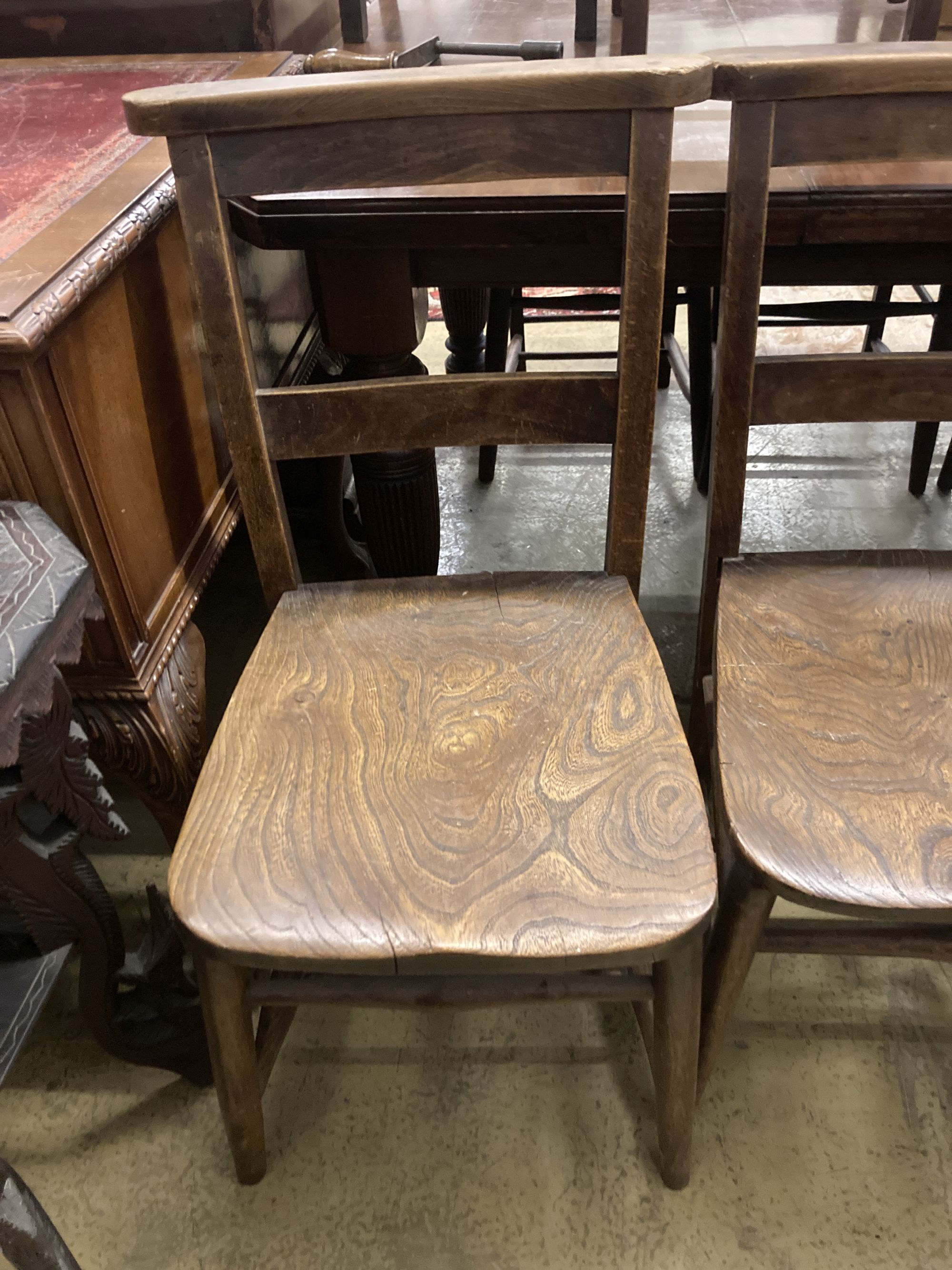 A set of four late Victorian elm and beech chapel chairs.